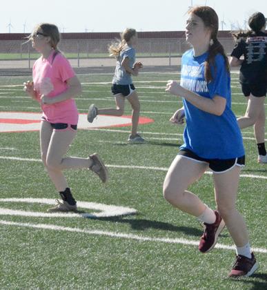Hermleigh sophomore Rachaelle Smith (left) and senior Haley Murphy ran sprints. Both Murphy and Smith were members of the Lady Cardinal basketball team that reached the regional finals this past season.