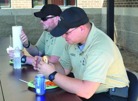 Scurry County EMS paramedics Jeremy Moody (left) and Adam Wester enjoyed a cookout lunch prepared by Big Country Electrical Cooperative employees on Wednesday.