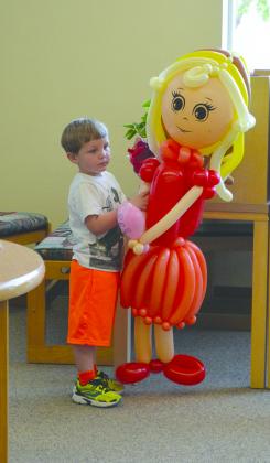 Zander Arnwine stood next to one of the balloon people at the Scurry County Library’s closing ceremonies for the summer reading program.