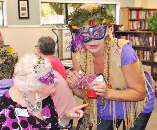 The Scurry County Senior Citizens Center hosted a Mardi Gras-themed murder mystery dinner Thursday. Theda Moore (left) played Blanche Le Bouef and Patty Torres played a hippie named Celine L. Schumacher. 