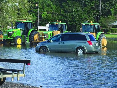 A van and three tractors were trapped in the water at Mauriceville following Hurricane Harvey.