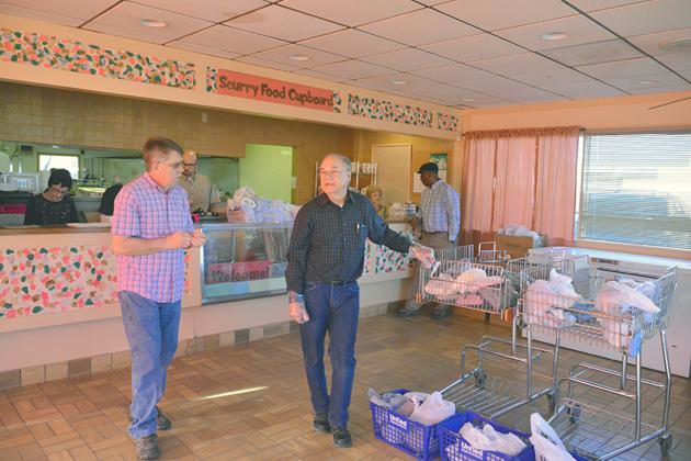 Pictured in the foreground are Food Cupboard co-directors Johnny Irons (left) and Gary Scott. In the background (l-r) are volunteers Marie Dunkinson, Matt Stidham, Ellie Dryden and Larry Rodgers.