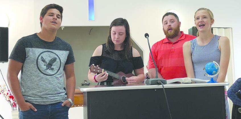 From left, Jax Collier, Grace Highfield, Eric Waits and Anzlee Hale lead the music portion of a service in Romania.