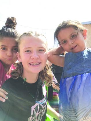 Anzlee Hale is pictured with two of the children she visited with in Tinca, Romania.