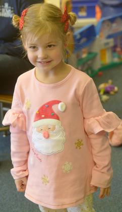  Noah Hoyle shows off her Santa shirt at the story time event.