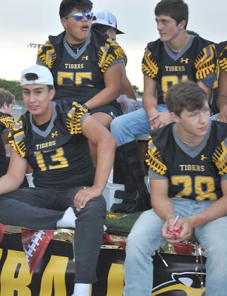 Snyder High School varsity football players Leeroy Tavarez (13), Cyrus Soria (55), Kolton Vess (81) and Kyler Teakell (28) were among the riders in Thursday’s homecoming parade through Towle Park. 
