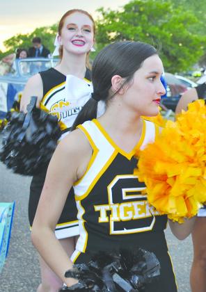 Snyder High School cheerleaders Tamryn Hite (left) and Baylee Garcia walked down the parade route.