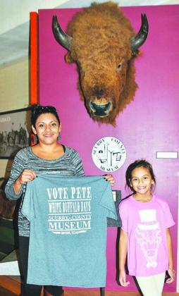 Scurry County Museum staff member Giana Winkler and her daughter, Brily Winkler, are pictured with Pete the Buffalo T-shirts, which will be sold during White Buffalo Days.