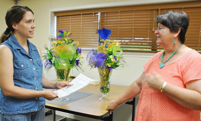 Daphene Thompson (left), Scurry County Senior Center activities director, talked to Stasia Blalock about the character she will play in Mardi Gras Mask, a potluck-style murder mystery dinner Thursday at the senior center.  Call the center  at 573-4035 to reserve a seat or participate in the play. 