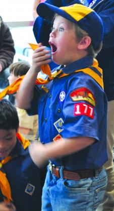 Justice Willson of Pack No. 177 jumped in excitement when his car won first place in the first round of the Snyder Cub Scouts Pinewood Derby at Wilson Motors.