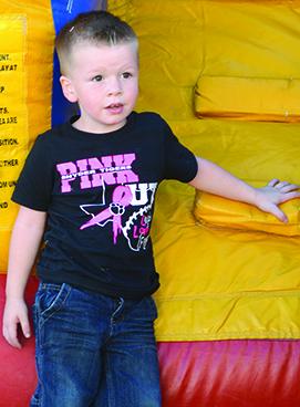 Deacon Mandrell, 3, wore one of the Pink Out T-shirts sold to raise money for the Snyder Cancer Fund at Friday’s tailgate party.