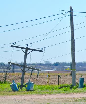 High winds that blew through the area Wednesday caused extensive property damage, including these snapped utility poles west of Patterson-UTI Drilling Company on West U.S. Hwy. 180.