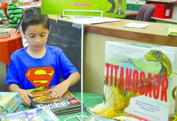  Gael Miranda was among the Snyder Primary School students looking for just the right book during the school’s annual book fair Tuesday. The book fair runs through Friday.