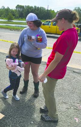 Rebekah Franklin (right) visited with hurricane victims at the supply distribution center in Mauriceville.