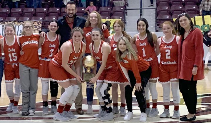 Members of the Hermleigh Lady Cardinals basketball team pictured with the regional quarterfinals trophy on the front row are (l-r) Makia Gonzales, Ryleigh Benitez and Rylee Teakell. On the back row are Aubree Myers, Rachaelle Smith, Brittany Smith, head coach Duane Hopper, Kaylee Weaver, Haley Murphy, Juli Munoz, Sarah Murphy and assistant coach Blythe Hopper. The Lady Cardinals advanced to the regional tournament for the third straight year with their 43-31 win over Guthrie Monday.