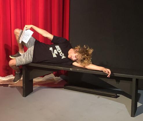 Will Haley reclines on a bench during a rehearsal of Leading Ladies at the Ritz.