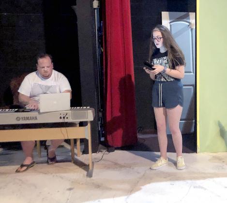 Director Clark Reed (left) and Gillian Crist rehearse a scene from Godspell.