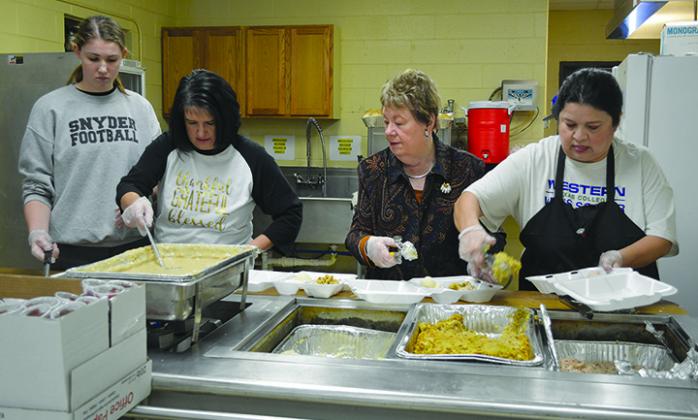 The Snyder Rotary Club and local volunteers distributed free meals to the community Thanksgiving Day. Pictured are (l-r) Franzie Luecke, Bobbie Hale, Elyndabeth Toland and Yolanda Ramos. 