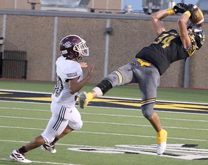 Snyder’s senior wide receiver Jayden Samaniego leaped to make the catch during Snyder’s 34-27 loss to Littlefield at Tiger Stadium Friday. Samaniego had two catches for 61 yards and a touchdown in the game.