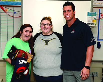 Hermleigh graduate Samantha Berry (center) was nominated by one of her students, Chloe Trejo (left), for the Star in the Classroom award for her work as a journalism teacher and advisor at Cypress Creek High School. As one of the winners, Berry was visited at school by Houston Texans football player Brian Cushing and was given tickets and sideline passes to a Texans game. 