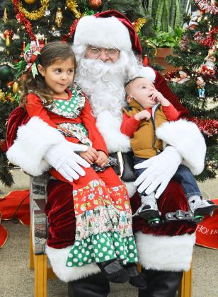 Three year-old Scarlett Jackson (left) and her brother, four-month-old Sylas Jackson, visited with Santa Claus at the Scurry County Library during the annual Christmas program on Thursday. Several activities were available for children and the library staff took pictures of the children with Santa Claus.