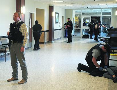 Snyder police Sgt. Mike Counts and other law enforcement officials and first responders secured a hallway and assisted victims during an active shooter drill at Cogdell Memorial Hospital on Wednesday.