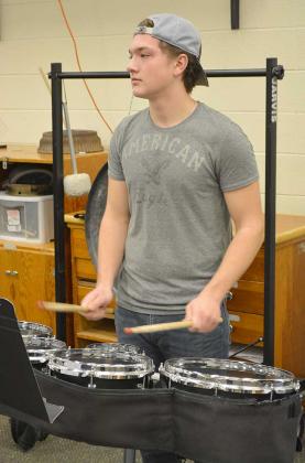 Snyder High School Pride of the West Marching Band member Brody Thompson and other percussion section members practiced in the high school band hall Tuesday afternoon.