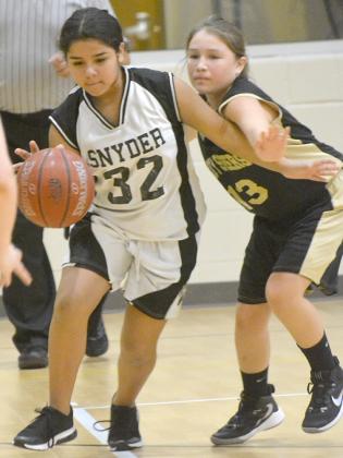 Snyder Junior High School seventh grader Ava Rojas dribbled past a defender during the Snyder Tournament Saturday. The seventh grade A-team went 2-0 in tournament play.
