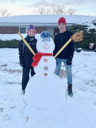 Pictured (l-r), Jaxon West and Jaden West built a baseball snowman in their front yard in Snyder.