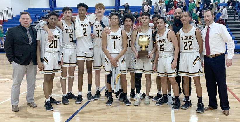 Members of the Snyder Tigers basketball team pictured with the bi-district trophy are (l-r) assistant coach Dustin Morrow, Yajat Bhakta, Eber Murillo, Teafale Lenard, Zach Miller, Corey Landin, James Roden, Jayden Samaniego, Gary Porter, Sammy Sosa, assistant coach Zach Garcia, Michael Jaramillo and head coach Lee Scott. The Tigers defeated Iowa Park, 55-35 in the bi-district playoffs in Abilene Tuesday.