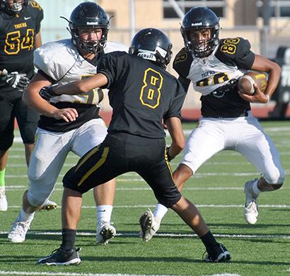 Maverick Hernandez (8) filled his gap while Corey Landin (88) followed the block from Troy Botts during Snyder’s football practice at Tiger Stadium Monday. The Tigers will travel to Slaton for a scrimmage at 5 p.m. Thursday.