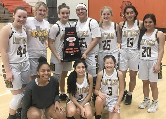 Members of the Snyder Lady Tigers basketball team pictured with the runner-up trophy on the front row are (l-r) Kamiah Davis, Abby Benitez and Taryn Nobles. On the back row are Mayce Herrington, Hayley Humphrey, Natalee James, Zalyn Jaramillo, Erin Crane, Melanie Martinez and Jalee Guerrero. 