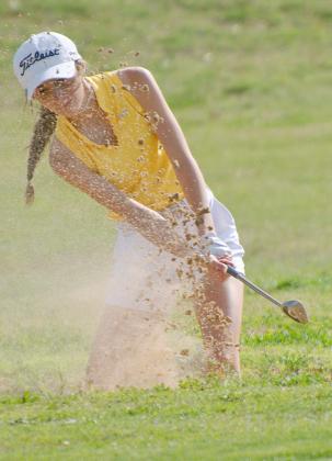 Snyder varsity golfer Tyleigh Price hits her ball out of the bunker during the final round of the District 5-4A tournament on Wednesday. 