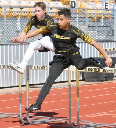 Snyder athletes Grayson Keele (left) and Jeremiah Valenzuela competed in the 100-meter hurdles at the Canyon Reef Relays at Tiger Stadium Thursday. 