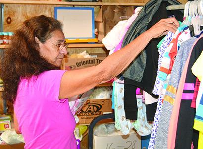 Jesusita Smith browses the selection of children’s clothes available at the Snyder Shares Free Store’s opening day today. The store will be open every Tuesday from 9 a.m. to 1 p.m. and provides people with baby clothes, diapers, toiletries and other household items they may need for free. The store is located behind the Diamond M building on Ave. J. 