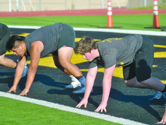 Snyder linemen Cyrus Soria (left) and Nathan Beaver take their stances Tuesday during practice at Tiger Stadium for the upcoming state lineman challenge.