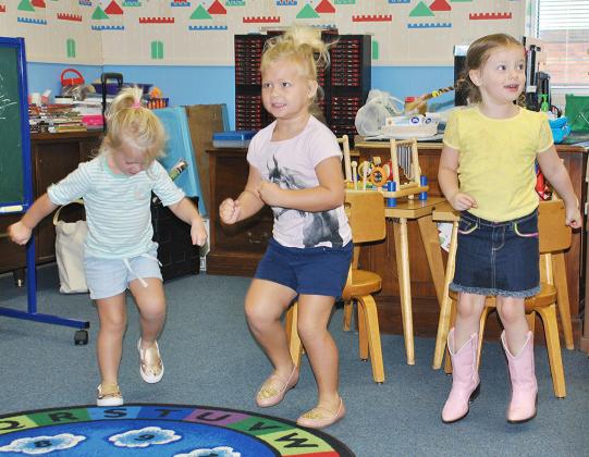 Scurry County Library story time participants (l-r) Lyla Early, Willa Early and Brinleigh Scates danced to Shake Your Sillies Out on Monday. They also studied insects and made an ant project. 