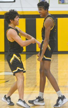 Snyder seniors Jayden Samaniego (left) and Teafale Lenard celebrated during the Tigers’ 61-42 win over Abilene Cooper Monday. The duo combined for 39 points and Lenard finished the day with 42 points in the Tigers two wins Monday.