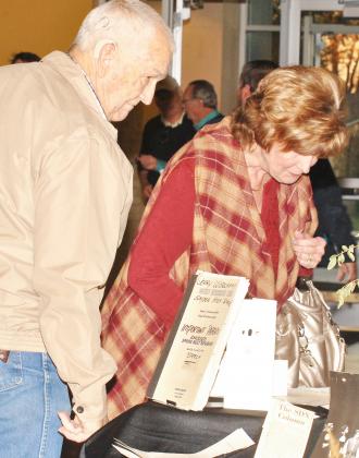 E.J. Gifford (left) and Judy Foree looked at the Snyder High School drama department memorabilia and Dr. Brad Vincent’s drama achievements displayed at the 2016 Snyder High School Theatre Gala on Saturday.