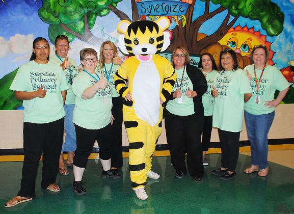 The new Snyder Primary School Tiger mascot will be named by students during the first few weeks of school. Pictured with the mascot are (l-r) Freda Malone, Dee Ann Jennings, Vicky Rowland, Kelly Anderson, Sherry Carroll, Sandra Luera, Gloria Ortegon and Amy Crist. 