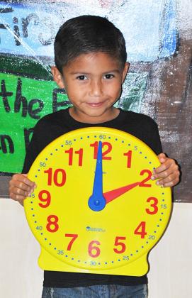 Myles Martinez, a student in Kimberly Krueger’s kindergarten class at Snyder Primary School, reminds everyone to move their clock back one hour as daylight saving time ends Sunday.