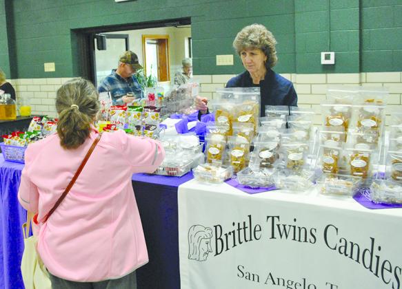 Melvina Floyd of Brittle Twins Candies & Gifts of San Angelo, assisted a customer during Snyder Trade Days this morning. Trade Days continues through 4 p.m. Saturday at the Towle Park armory and barn.