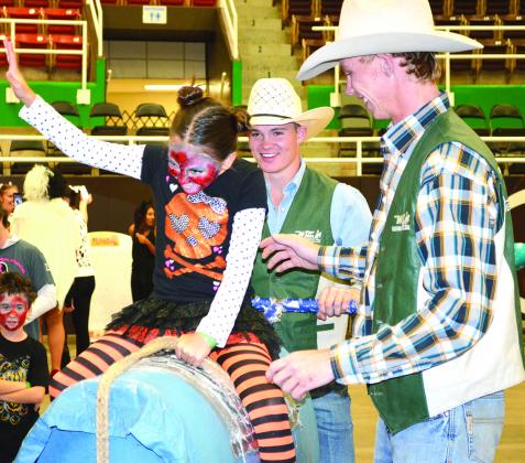 Trinity Trueman, 10, rode a barrell bull with the help of Western Texas College rodeo team members Clayton Sellars and Tom Knight during Monday’s Fall Fest at The Coliseum. All proceeds will benefit the Scurry County United Way campaign. As of Monday afternoon, the United Way campaign had raised $47,000, which represents 40 percent of the goal of $120,000. 