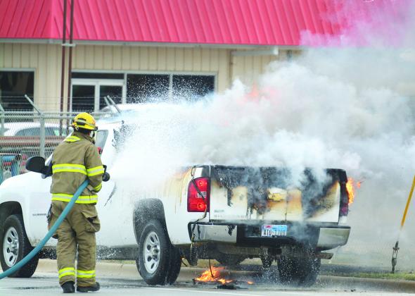 Snyder firefighter Nathan Evans put out a vehicle fire on Coliseum Drive in front of 7-Eleven at 10:57 a.m. Wednesday. 