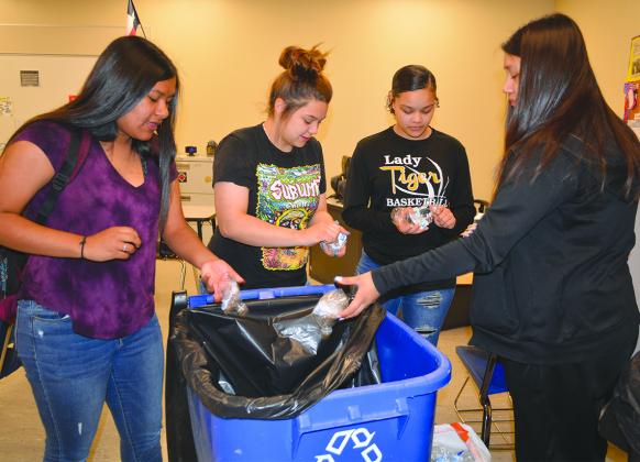 Eighth graders (l-r) Marissa Amaya, Krisy Villegas, Ke’Odisty Daniels and Marisol Amaya took lids off of watter bottles.