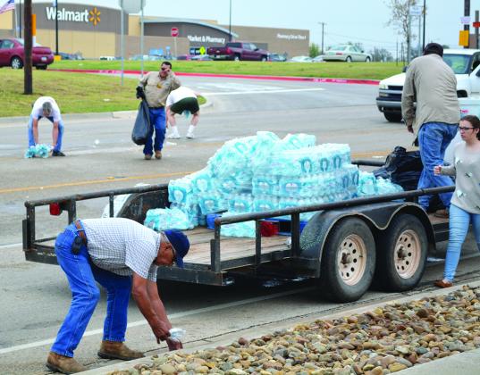 A group of people picked up cases of bottled water that fell off of a trailer on College Ave. in front of West Texas State Bank at 9:15 a.m. today. No accidents were reported and Snyder police officers helped with traffic control. 