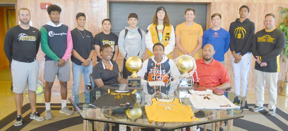 Snyder High School senior Alonzo Wesley (seated, center) signed to play basketball with Northwest Kansas Technical College on Tuesday. He is pictured with his parents Freda and Barron Wesley. Members of the Snyder basketball team standing are (l-r) head coach Lee Scott, Christian Gaona, Corey Landin, Jayden Samaniego, Sammy Sosa, Talon Vandygriff, Logan Greene, Nathan Kendrick and assistant coach Dustin Morrow.