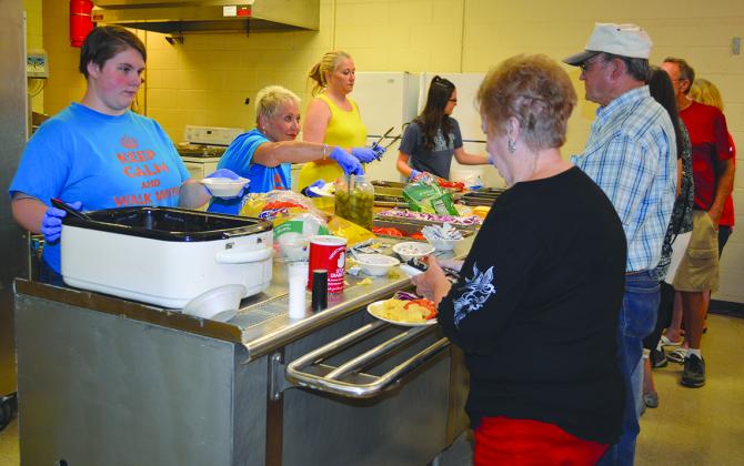 From left, Tuesday Waltz, Nancy Harris, Ronda Robinson and Whitney Tubbs served food during Wednesday night’s burger and beans supper at The Coliseum. About 170 meals were served, with proceeds benefiting the American Diabetes Association.