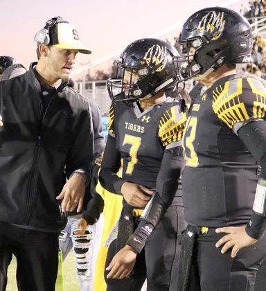 Snyder head football coach Wes Wood (left) talked strategy with quarterbacks Corey Landin (center) and Leeroy Tavarez during a loss to Monahans at Tiger Stadium Friday. The Tigers will be on the road to face the Midland Greenwood Rangers Friday.