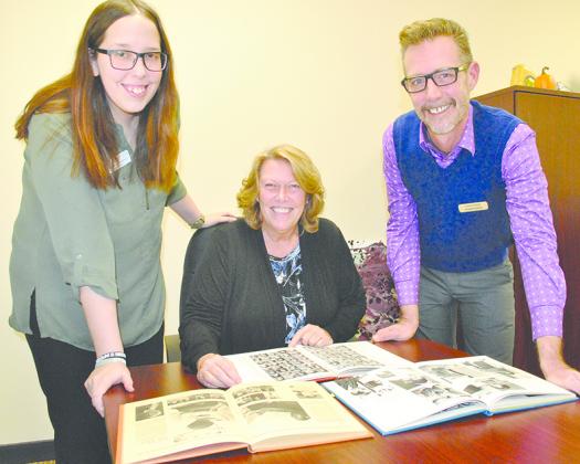 Western Texas College President Dr. Barbara Beebe (seated), WTC bookstore manager Hannah Chaney (left) and marketing director Lorenzo Sands looked at Trailblazer yearbooks to get an idea of what might be buried in a time capsule located in the courtyard. The college will open the time capsule on Nov. 18, 2019 to commemorate the 50th anniversary of the vote to establish the Scurry County Junior College District.